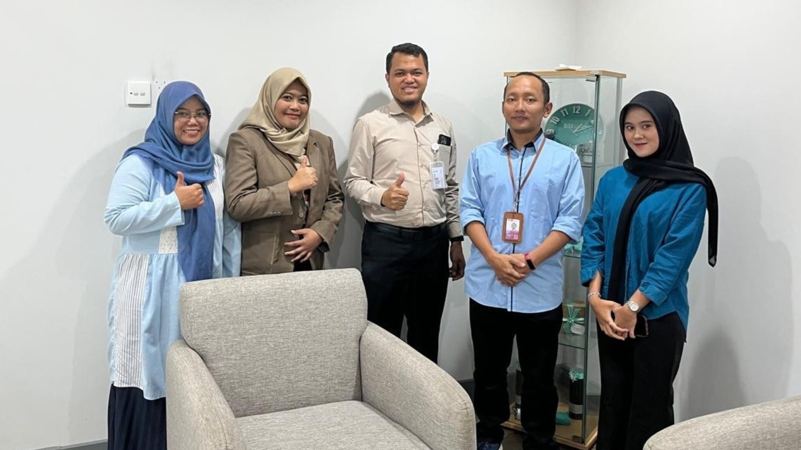 Mahasiswa FEBI UIN Raden Mas Said Surakarta berdiri rapi bersama tim BSI Karanganyat usai sesi monitoring, mengenakan kemeja formal dengan latar branding bank dan suasana ruang kerja profesional.